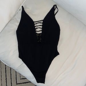 Brooklyn Karma black bodysuit with cross strap detailing and plunging neckline